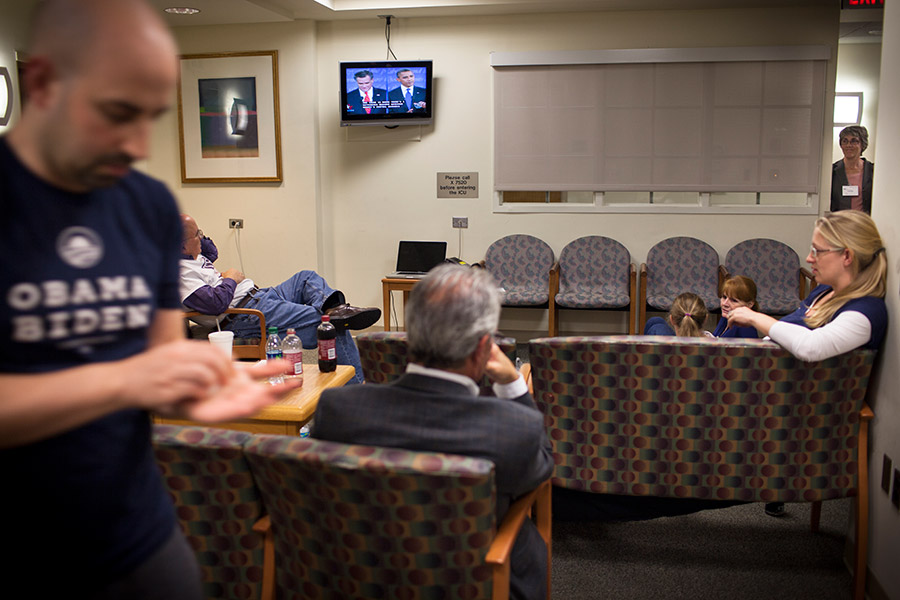 Family gathers to watch the first of three presidential debates between Barack Obama and Mitt Romney in the hospital waiting room.