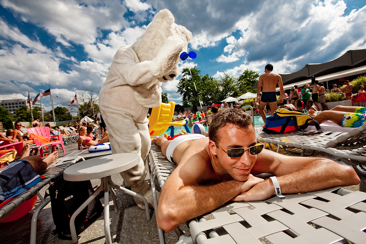 A polar bear applies sunscreen to a sunbather at the Capital Skyline Hotel in Washington, D.C.